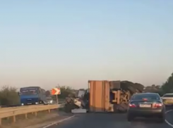 Перегруженный КамАЗ опрокинулся на съезде с моста под Ростовом на видео